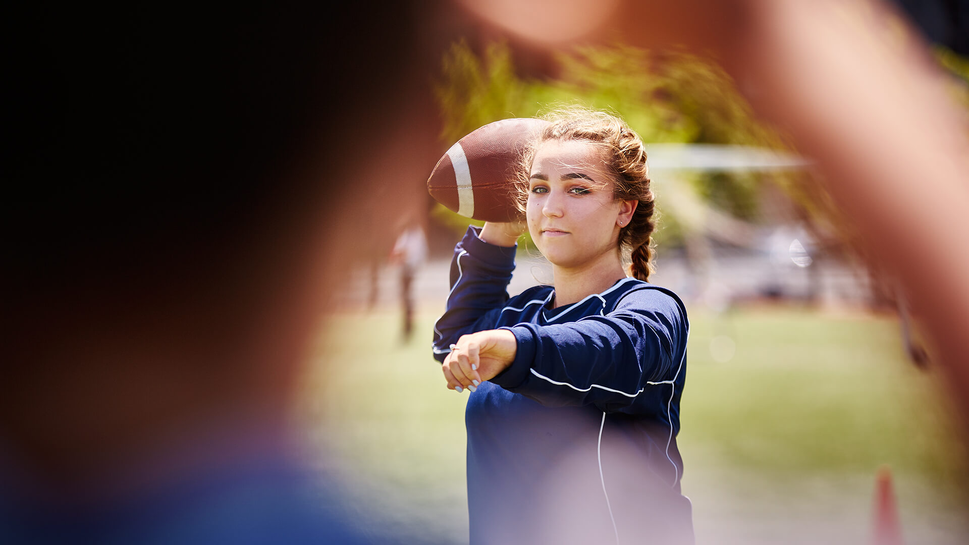 female student throwing football